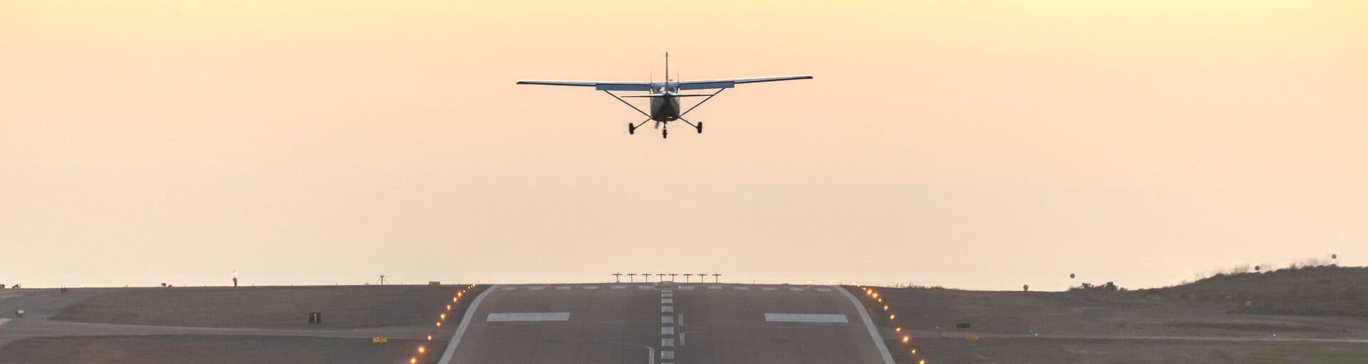 Aircraft on runway at sunset